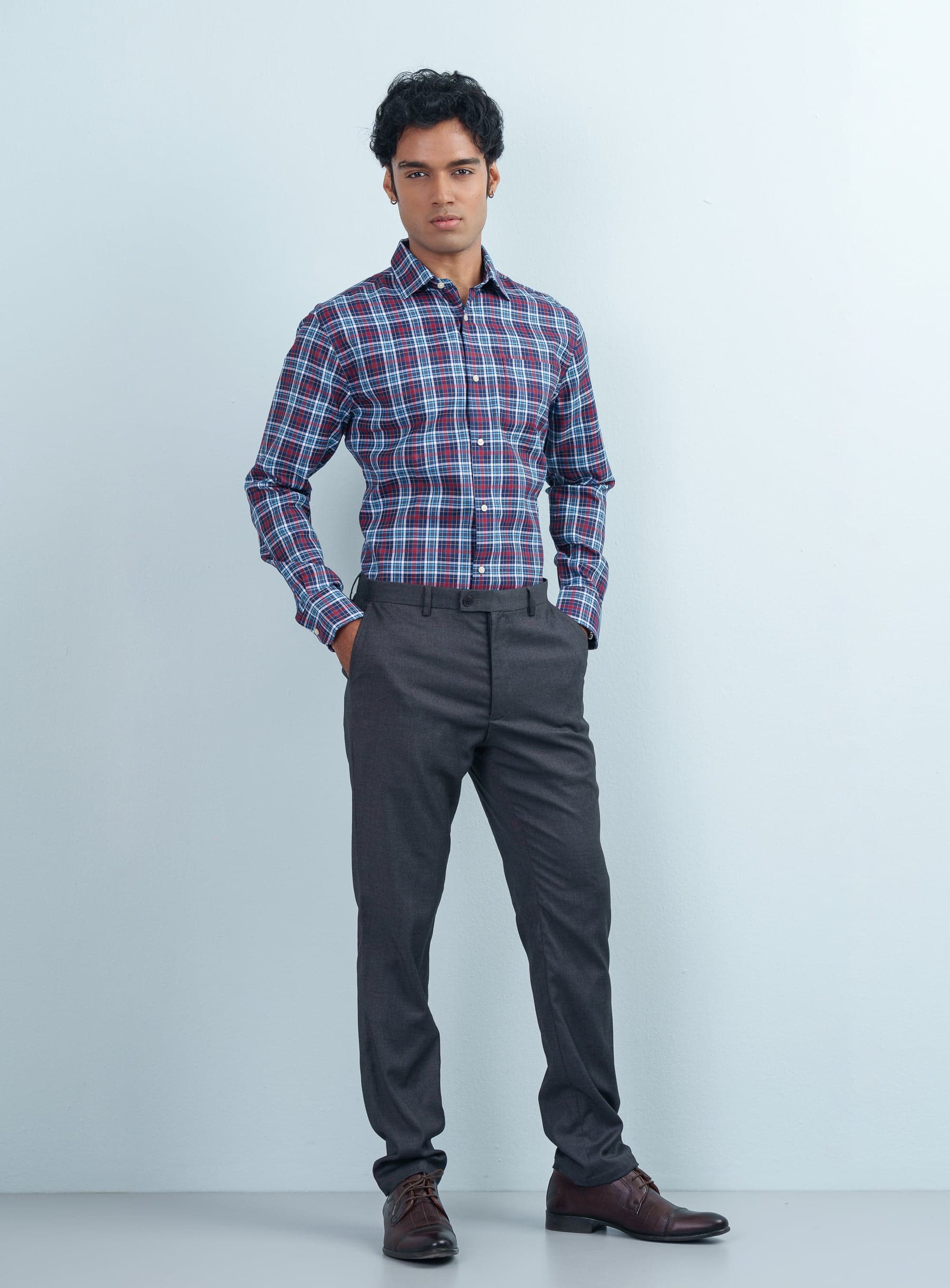 Full-length view of a model styled in a Multicolor Tartan Plaid Formal Shirt full sleeve, charcoal grey trousers, and brown leather shoes.